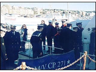 Crew members of the present H.M.S. Spartan (a nuclear submarine) going out to lay a wreath where the cruiser H.M.S. Spartan was sunk.